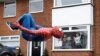 Jason Baird is seen dressed as Spiderman during his daily exercise to cheer up local children in Stockport, as the spread of the coronavirus disease (COVID-19) continues, Stockport, Britain, April 1, 2020. REUTERS/Phil Noble