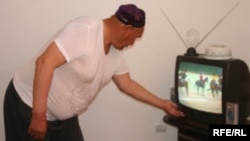 Житель Казахстана смотрит телевизор. Иллюстративное фото.