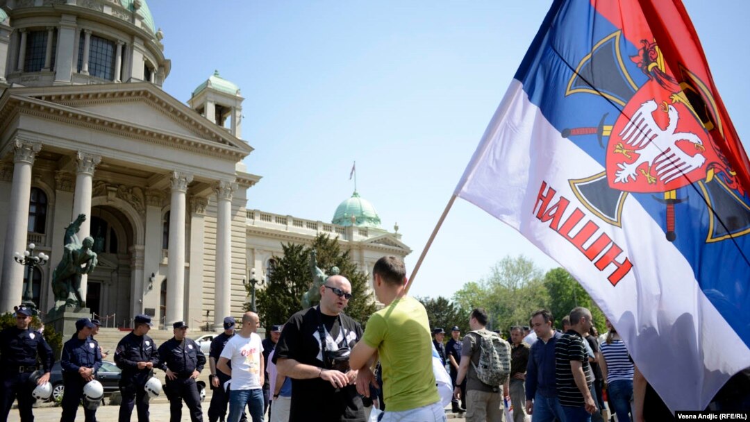 Supporters of right-wing movements shout slogans such as "Kosovo Is Serbia" in front of the National Assembly in Belgrade on April 26.