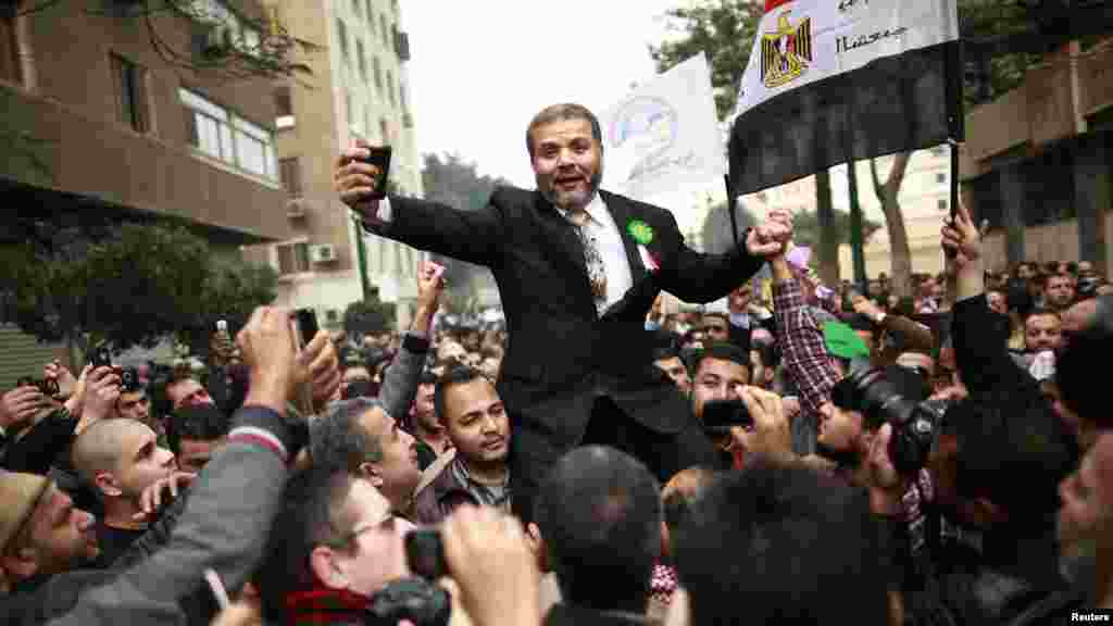 Muslim Brotherhood supporters celebrate outside Egypt's parliament in Cairo on January 23. Lawmakers were holding their first session since an election put Islamists in charge of the assembly following the overthrow of President Hosni Mubarak in February 2011. (Reuters/Suhaib Salem)