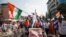 Demonstrators wave the national flag of India and shout slogans during a protest against a new citizenship law, on the outskirts of Mumbai, December 18, 2019.