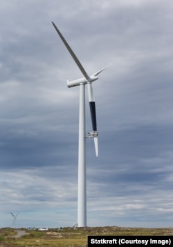 A wind turbine having a blade painted black at the Smola wind farm during research on bird strikes