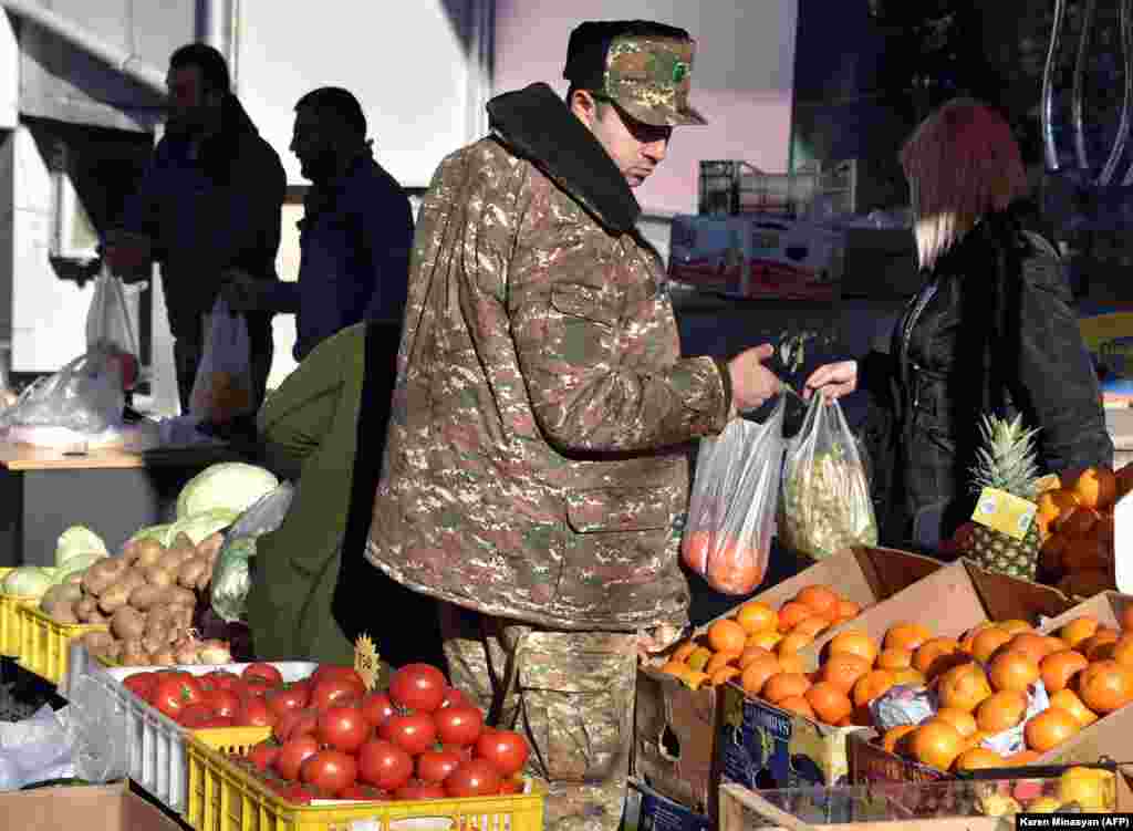 An ethnic Armenian soldier shops in a fruit market in central Stepanakert on November 24.