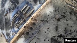 Aerial footage shot by a drone shows shell craters from intense fighting at Donetsk's international airport.