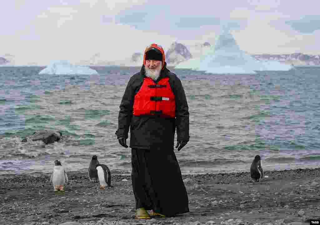 Russian Patriarch Kirill, wearing a life vest and surrounded by penguins, poses at Russia's Bellingshausen scientific station on the Island of Waterloo, Antarctica, on February 18. (TASS)