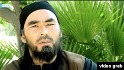 Screen grab of the Uzbek IS militant Abu Hussein al-Uzbeki on a video with the Furat Media logo.