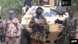 Nigeria -- A video grab shows the leader of the Islamist extremist group Boko Haram Abubakar Shekau (C) delivering a speech, undated