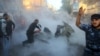 Palestinians extinguish flames on the car of Ahmed al-Jaabari, head of the military wing of the Hamas movement, after it was hit by an Israeli air strike in Gaza City on November 14. 