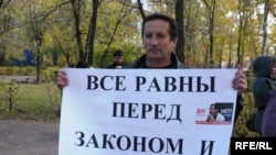 A supporter of Yevgeny Zhovtis protests in October.