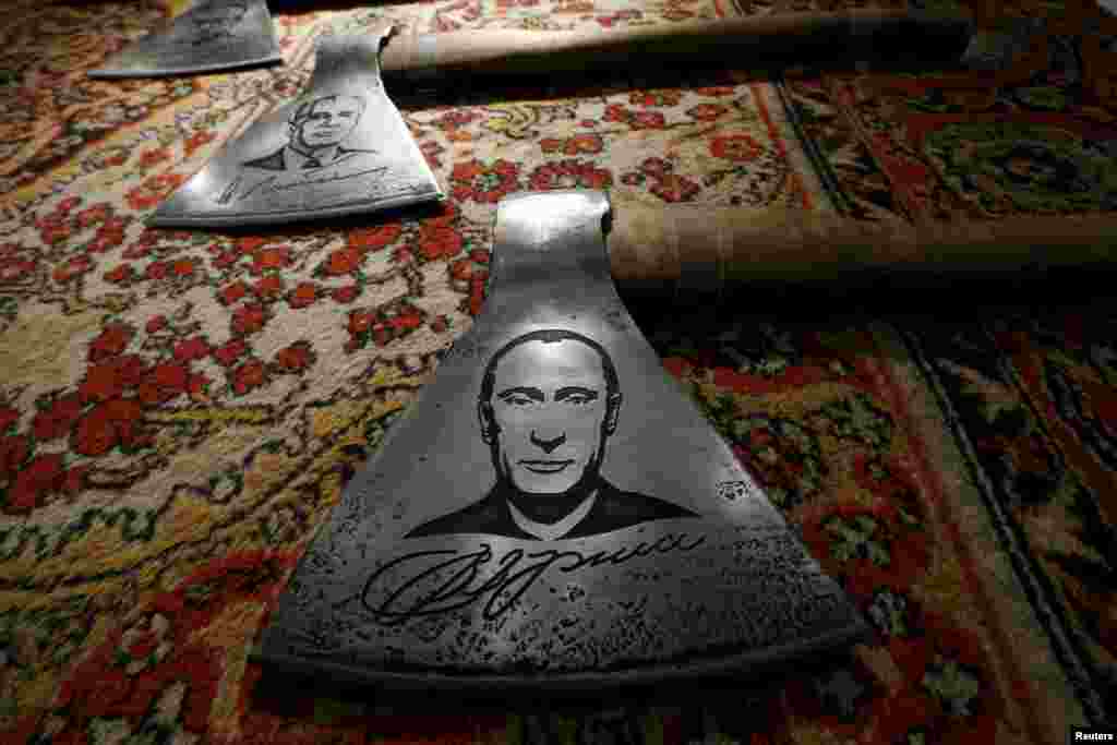 An ax featuring a portrait of Russian President Vladimir Putin by Russian artist Vasily Slonov is seen during an exhibition titled Quilted Cavaliers Of The Apocalypse in Moscow. (Reuters/Sergei Karpukhin)