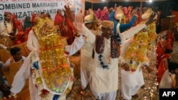 Bridegrooms celebrate during a mass marriage ceremony in Karachi. (file photo)