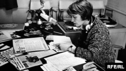 A broadcaster prepares a music program.