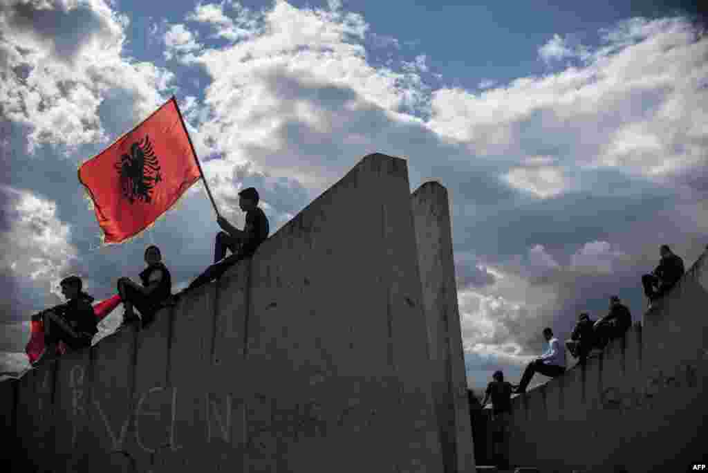 A child waves an Albanian flag during a funeral ceremony for eight ethnic Albanians who were killed during fighting with Macedonian police in Kumanovo earlier this month. (AFP/Armend Nimani)