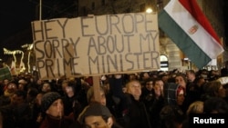 A man holds up a sign during a protest in central Budapest.