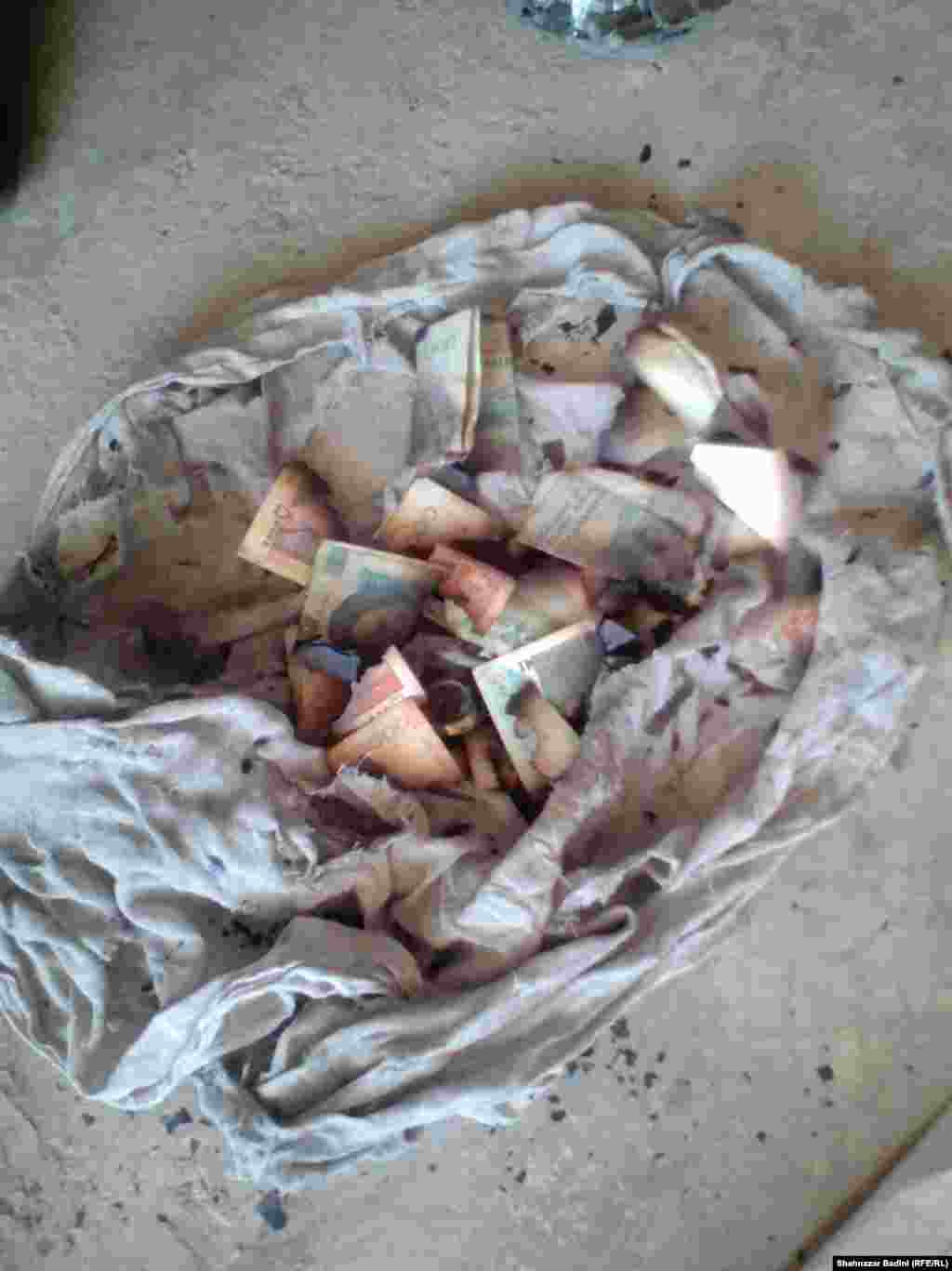 The remains of Mansur’s shirt and half-burnt Iranian and Pakistani bank notes.