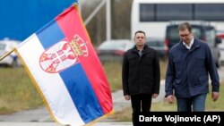 Aleksandar Vučić (desno), predsednik Srbije, i Aleksndar Vulin, aktuelni ministar unutrašnjih poslova (u vreme kada je nastala ova fotografija ministar odbrane), pored zastave Srbije tokom vojne vežbe na aerodromu Lisičji jarak nedaleko od Beograda - 17. novembar 2017. 