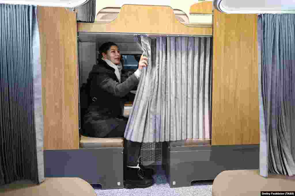 A woman tests the curtains in the Sochi mock-up. Aleksandr Loshmanov, a spokesman for the Russian Railways subsidiary that will make the new carriages, said all passengers will have their own ventilation controls&hellip;