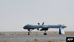 Afghanistan -- A US Predator unmanned drone armed with a missile sitting on the tarmac of Kandahar military airport, 13Jun2010