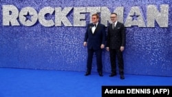 Британський співак Елтон Джон (ліворуч) та його чоловік Девід Ферніш на прем’єрі фільму про Джона «Рокетмен». Лондон, 20 травня 2019 року