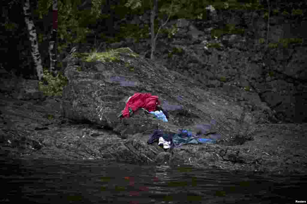 Niclas Hammerstrom of Sweden won a prize for news with this image showing the aftermath of Anders Breivik&#39;s massacre on the island of Utoya. In an attempt to escape the killing, many children dumped their clothes and tried to swim for safety.
