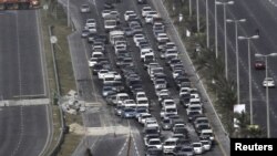 Cars line up at a checkpoint set up by Gulf Cooperation Council forces deployed in Bahrain.