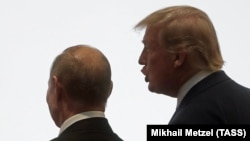 Russian President Vladimir Putin (left) and U.S. President Donald Trump walk together during a G20 leaders summit in Japan in 2019. 