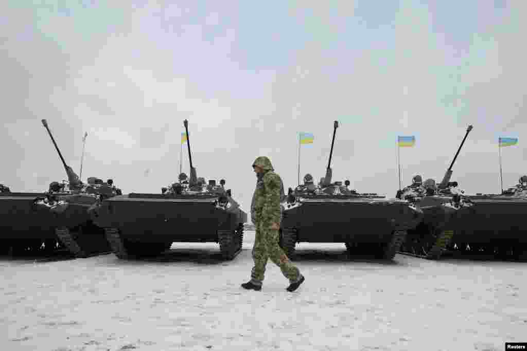 A Ukrainian serviceman walks past reconditioned armoured personnel carriers during a ceremony to hand over weapons, military equipment and aircrafts to the army at a firing range outside Zhytomyr on January 5. (Reuters/Valentyn Ogirenko)​