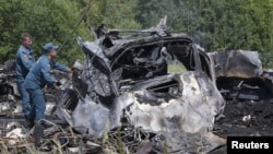 Emergency Situations Ministry personnel work at the scene of a bus crash in Siberia that left 11 people dead. 