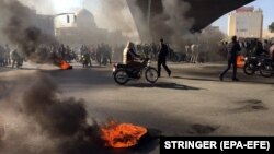 Iranian protesters block a highway following a fuel price increase in Isfahan, Iran, 16 November 2019.