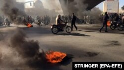Iranian protesters block a highway amid angry protests against a fuel price increase, in Isfahan on November 16.