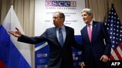 Serbia -- Russian Foreign Minister Sergei Lavrov (L) Russian Foreign Minister Sergei Lavrov (L) invites US Secretary of State John Kerry to a sitting area as he arrives for their bilateral meeting alongside the annual OSCE Ministerial Council meeting in B