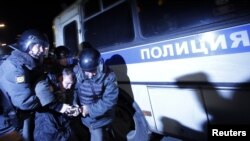 Police detain an activist during a rally to protest the results of the parliamentary elections in Moscow on December 6.