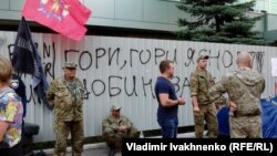 A metal fence covered with signs reading "Burn, Inter, burn!" and "Inter is a Kremlin agent!" erected after the fire remained in front of the TV offices on September 7.