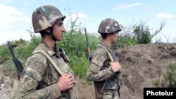 Ethnic Armenian soldiers take positions on the front line in northeastern Nagorno-Karabakh.