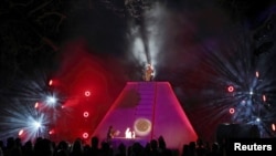 A Mayan priest sits atop a pyramid as Richard Garriott addresses guests at his "End of the World Soiree" dress rehearsal in Austin, Texas. 