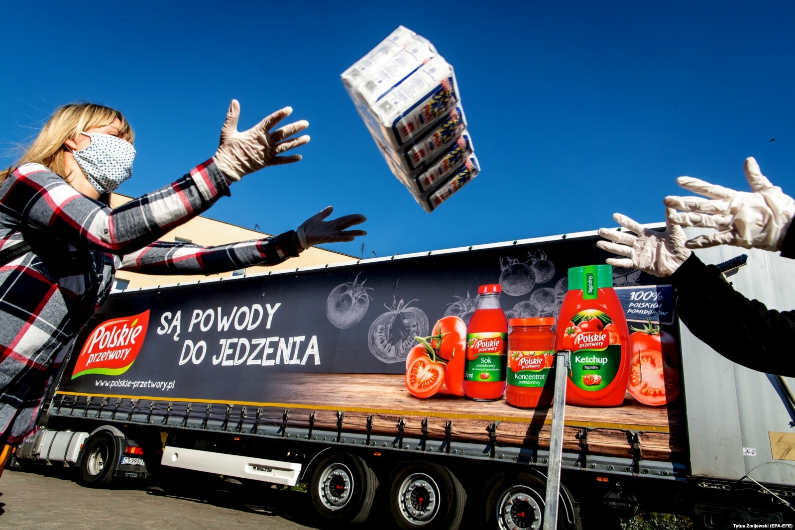 Workers load a truck with food aid in Bydgoszcz, Poland, on April 8. Two Polish companies, Polski Cukier and Polskie Przetwory, donated food products to help those most in need because of the coronavirus pandemic.