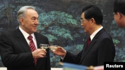 Kazakhstan's President Nursultan Nazarbayev (left) toasts with his Chinese counterpart, Hu Jintao, during a signing ceremony at the Great Hall of the People in Beijing on February 22.