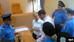 Former Prime Minister Yulia Tymoshenko (center) attends a session of Kyiv's Pecherskiy district court on August 5.