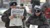 Russian police officers read newspapers on the street in central Moscow. (file photo)