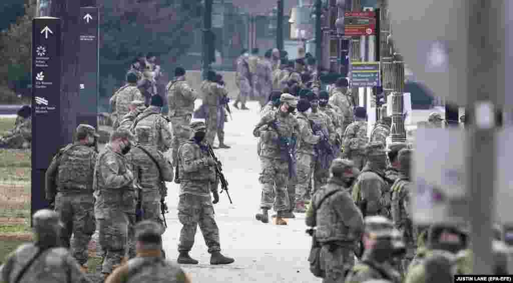 National Guard soldiers stand guard on the grounds around the U.S. Capitol building in Washington, DC, January 14, 2021. EPA-EFE