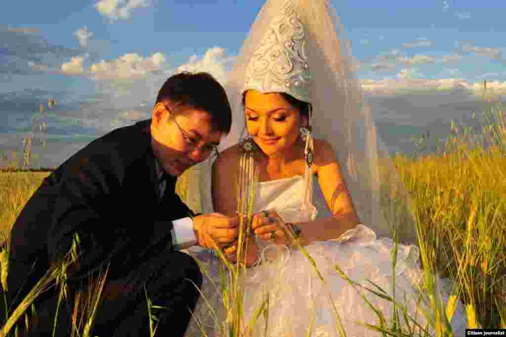 A bride wearing a traditional Kazakh wedding outfit.