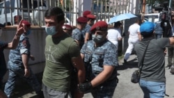 Armenia -- Police detain a supporter of Prosperous Armenia Party leader Gagik Tsarukian near the parliament building in Yerevan, June 16, 2020.