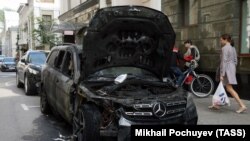 A burned car is seen near the office of lawyer Konstantin Dobrynin in Moscow on September 11.