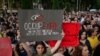 A protester holds a sign in reference to demonstrators who lost their eyes in violence or were temporarily blinded by tear gas during clashes with police on June 20. Police used rubber bullets and tear gas against the crowd, with hundreds of people being injured, including many police.<br />
&nbsp;