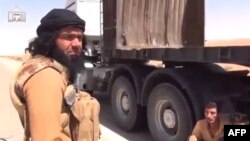 Iraq -- A video grab allegedly shows Shaker Wahib al-Fahdawi (L), the leader of Ussud Al-Anbar talking to Syrian truck drivers (R) after stopping their convoy at a highway at an undisclosed location in Anbar province, undated