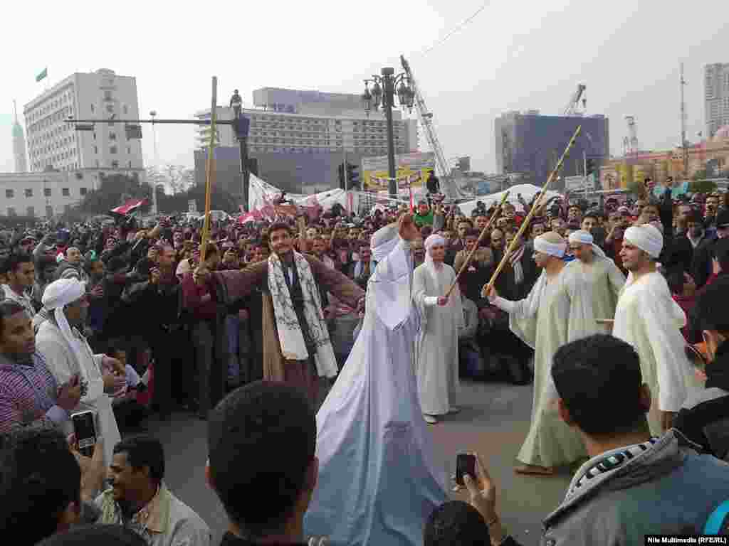 Here in Tahrir Square, Egyptian dancers perform a traditional "Dance of Sticks” to entertain protesters.