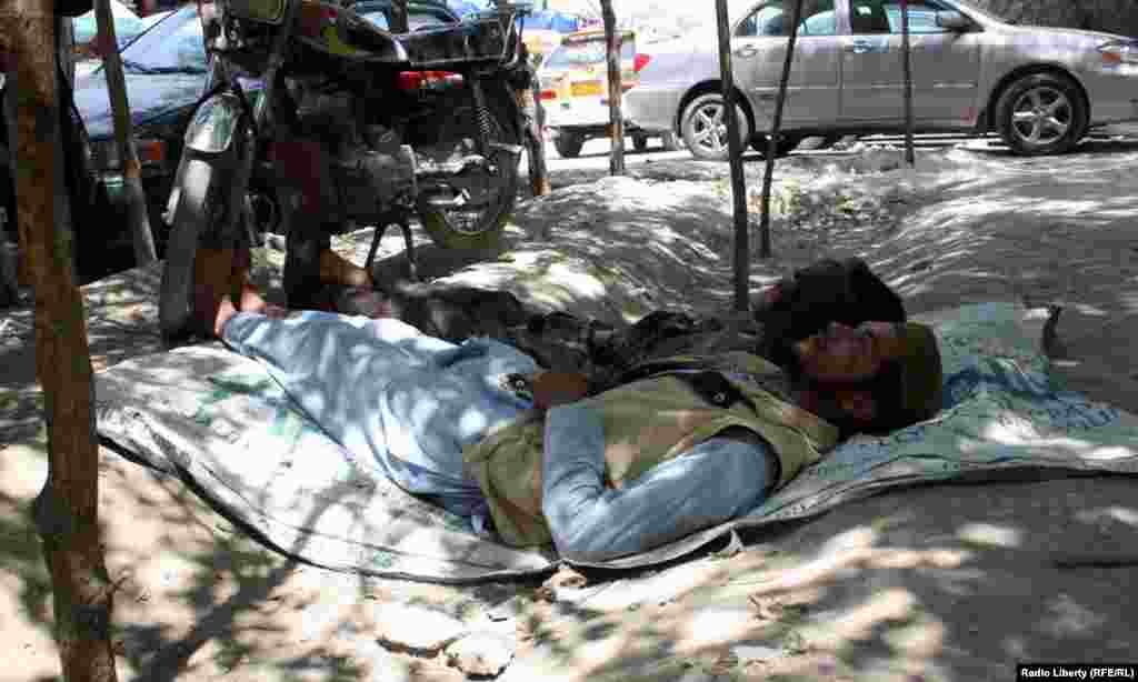 Kabul residents shelter in the shade amid temperatures of 39 degrees Celsius on July 29.