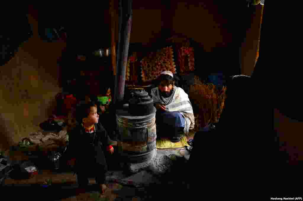 An internally displaced family warm themselves around a wood-burning stove at a refugee camp on the outskirts of Herat, Afghanistan. Avalanches, flooding, and harsh winter weather have killed more than 130 people across Pakistan and Afghanistan in recent days, leaving others stranded by heavy snowfall. (AFP/Hoshang Hashimi)