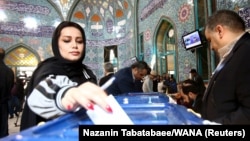 A woman casts her vote during parliamentary elections at a polling station in Tehran, Iran. February 21, 2020. 