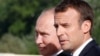 Russian President Vladimir Putin (left) and French President Emmanuel Macron speak during a meeting in St. Petersburg on May 24.